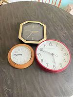 Group shot of all three wall clocks showing sizes, colors and designs