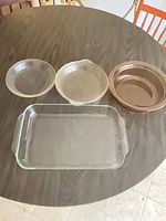Four glass bakeware pieces on table