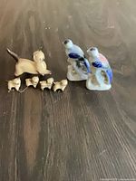 Full lot view showing mother cat, three kittens, two bird figurines