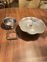 Three metal items: tray, bowl, ashtray