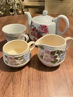 Group shot of teapot, teacup, creamer, sugar bowl
