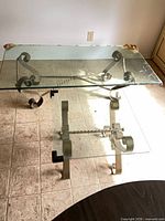 Rectangular coffee table and square end table showing glass tops and metal bases