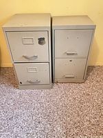 Front view of both beige metal 2-drawer filing cabinets
