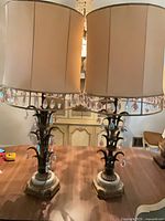 Full view of both matching lamps with shades and crystal prisms on marble bases