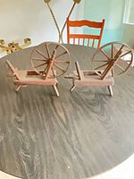 Both miniature spinning wheels on table