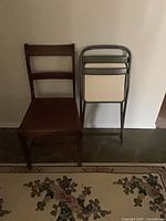 Wood side chair and metal folding chair side by side