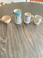 All four ceramic mugs grouped on table