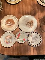 Five decorative porcelain plates laid out on table