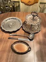 Group shot showing all five silver-tone serving pieces