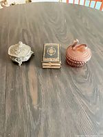 Three trinket boxes closed, showing overall forms and materials