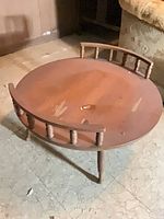 Top view of round coffee table showing overall design and surface wear