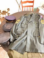 Uniform tunic with insignia and three caps