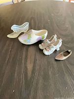 Group of five miniature shoes showing materials and styles