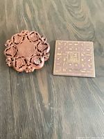 Both items together: wooden trivet and ceramic hieroglyph tile