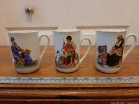 Three mugs front view with ruler for scale