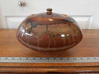 Side view of glazed ceramic fire pot showing shape and finish