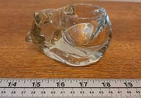 Side profile of crystal sleeping cat showing length