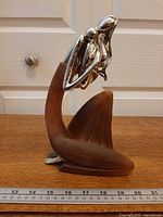 Full view of sculpture with ruler for scale