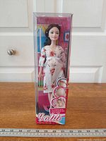 Full view of boxed pregnant fashion doll on table