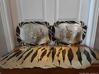 All ten placemats displayed; two upright showing design, remainder stacked