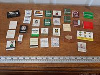 All 30 matchbooks laid out with ruler for scale