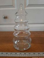 Full view of glass Christmas tree jar with ruler for scale