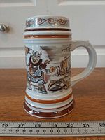 Full view of porcelain Viking stein next to ruler showing ~6.75 in height