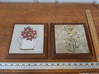 Both framed tile trivets side by side with rulers for scale