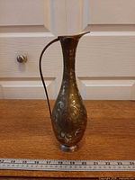 Front view showing full height and etched design with ruler for scale