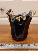 Front view of vase showing free-form shape and color with ruler for scale