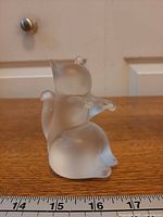 Left side view of frosted crystal squirrel figurine with ruler for scale