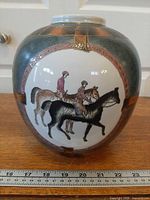 Front view showing horse and jockey artwork and overall shape with ruler for scale