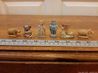 All six Wade Whimsies lined beside ruler for scale