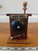 Front view showing bell, "BAR BELL" plate and "RING FOR ANOTHER ROUND" base text