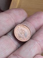 Reverse of coin showing crown, "NEW PENNY" and "1/2"