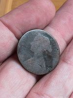 Obverse side showing Queen Victoria profile, toned surface