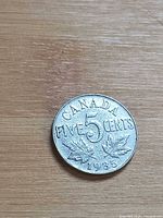 Reverse showing CANADA FIVE CENTS 5 and maple leaves, date 1935