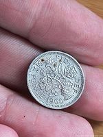 Reverse floral design with date 1960 and drilled holes