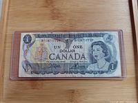 Obverse of 1973 Canada $1 banknote in clear holder