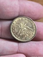 Reverse showing crossed rifles, olive branch, denomination and date