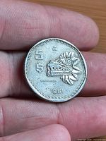Obverse of 1981 $5 Mexican coin showing Quetzalcoatl head, denomination and date