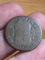 Obverse view showing rectangular motif and partial "FR" lettering