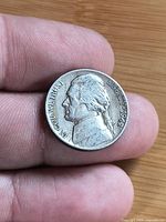 Obverse of Jefferson nickel showing portrait, motto and date