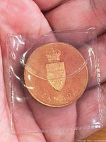 Obverse showing crowned shield of arms and word CANADA