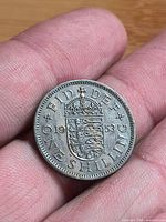 Reverse of 1953 one shilling coin showing crowned English shield, date 1953 and legend ONE SHILLING