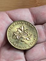 Obverse showing maple leaf design and bilingual text