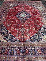 Full view of entire handmade Persian Kashan rug showing pattern and borders