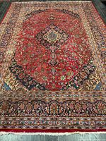 Full view of entire rug showing size, pattern, borders, and wear