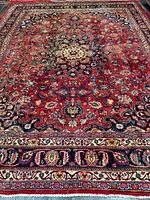 Full view of Persian rug showing overall pattern and borders