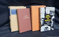 Four standing books showing covers and spines